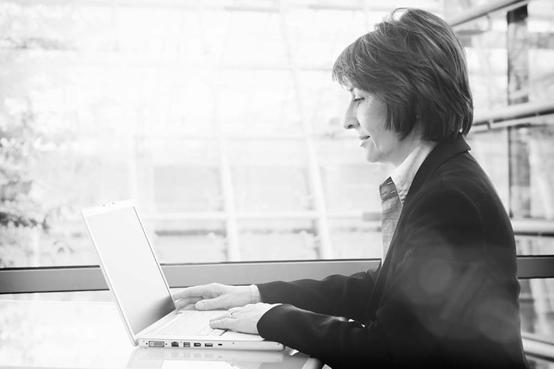 Senior businesswoman working with laptop at office.