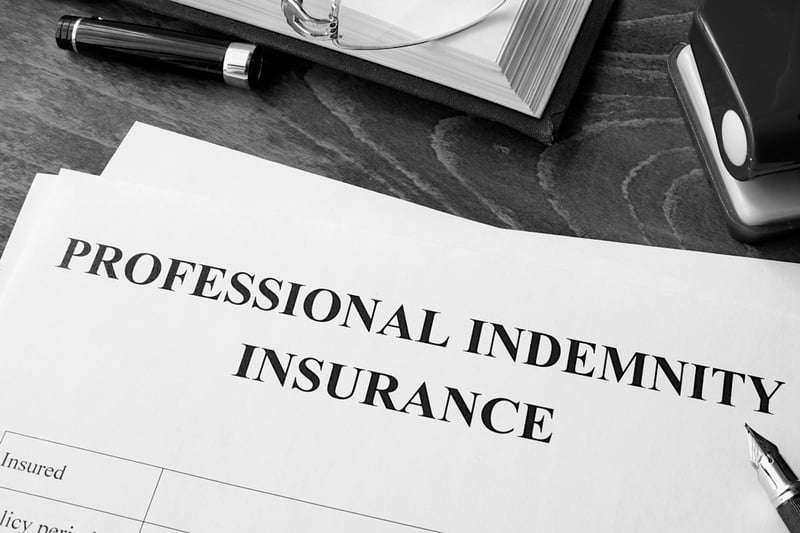 professional indemnity insurance policy papers on an office desk