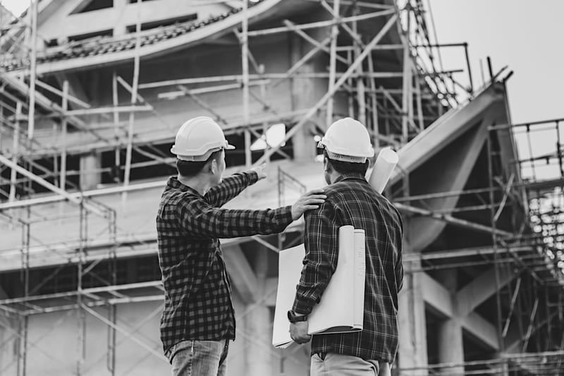 two construction workers observing construction jobsite