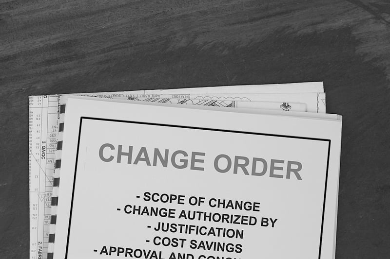 change order papers on desk describing scope of change and authorization