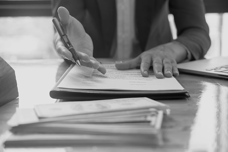 surety bond broker sitting at desk and offering help with notepad and pen