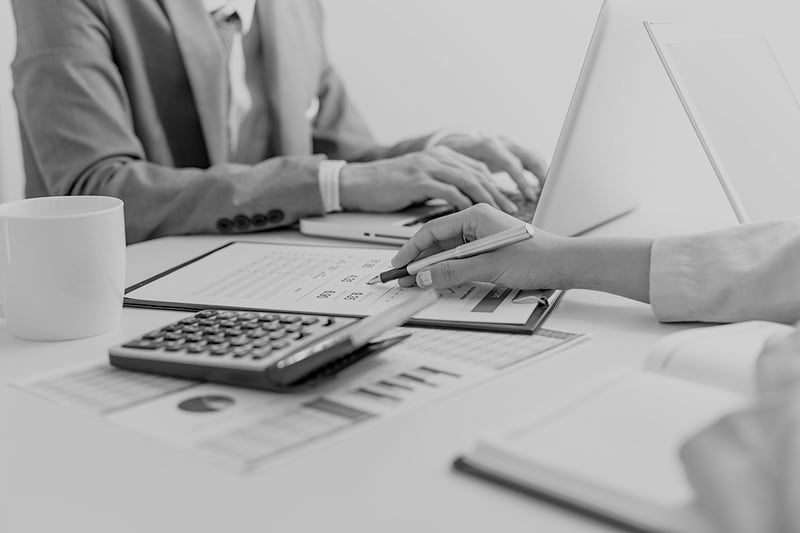 two business workers reviewing indemnity agreement contract at desk