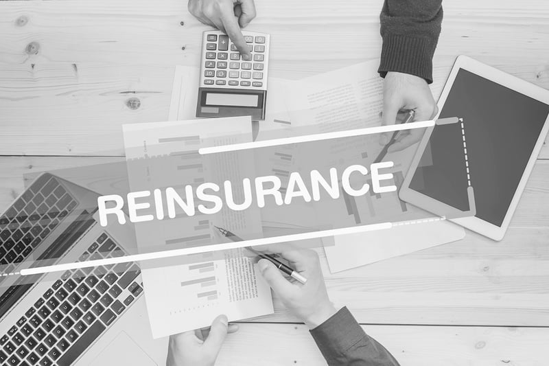 business insurance meeting with text that reads reinsurance