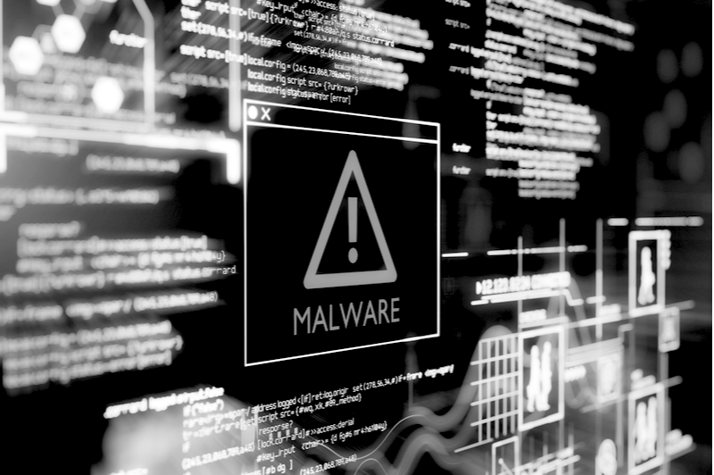 Malware notification on a computer screen with html code running in the background.