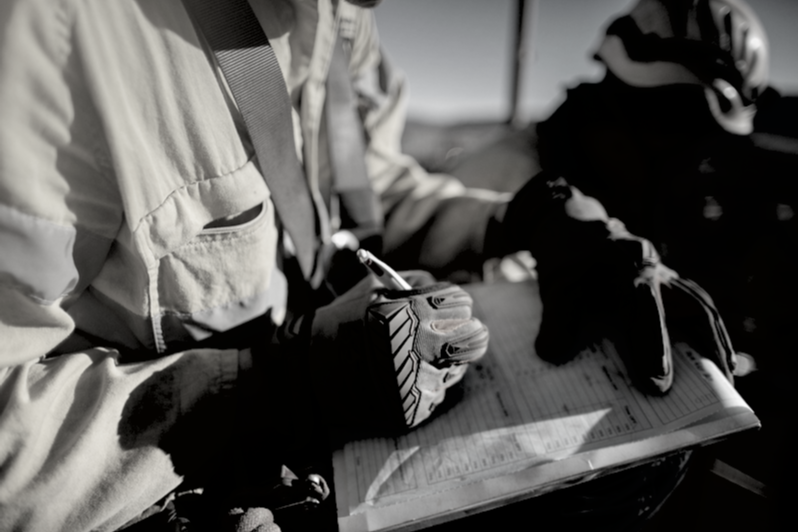 Construction worker on a jobsite with contract for risk management, and hard hat