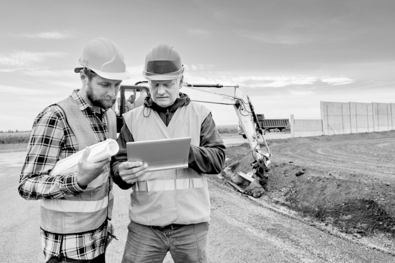 Construction Workers reviewing current insurance plan 