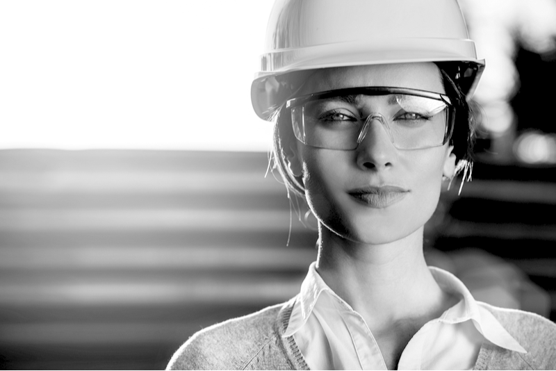 Woman in construction hat with safety googles