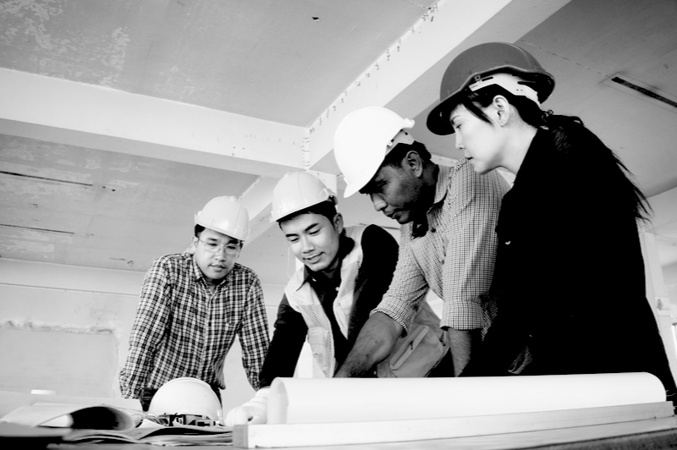 Engineers wearing safety helment meeting and discuss for work planning on site