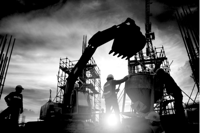 tractor and digger with concrete machine on a construction site