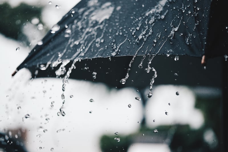 umbrella with water cascading off of it.