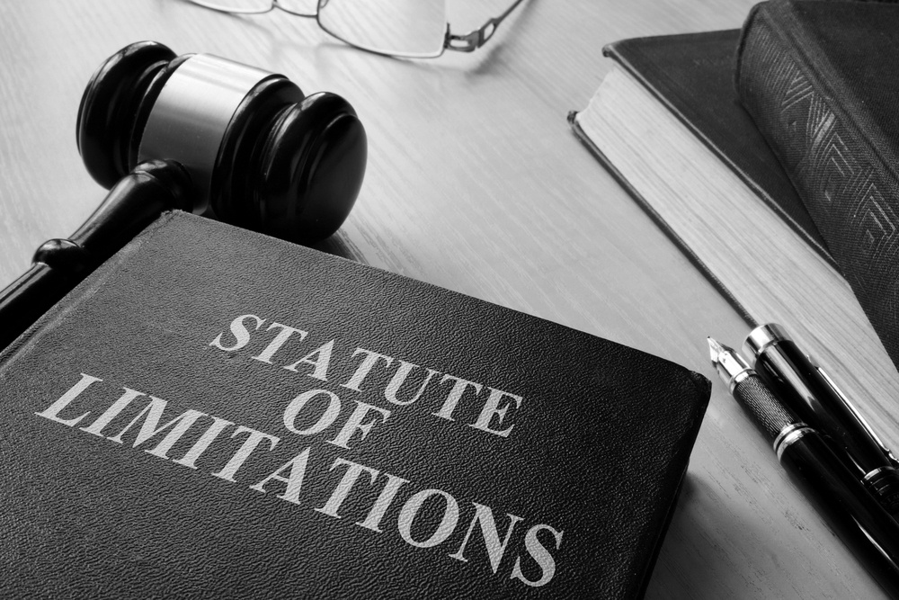statute of limitations book on a desk with pen and mallet