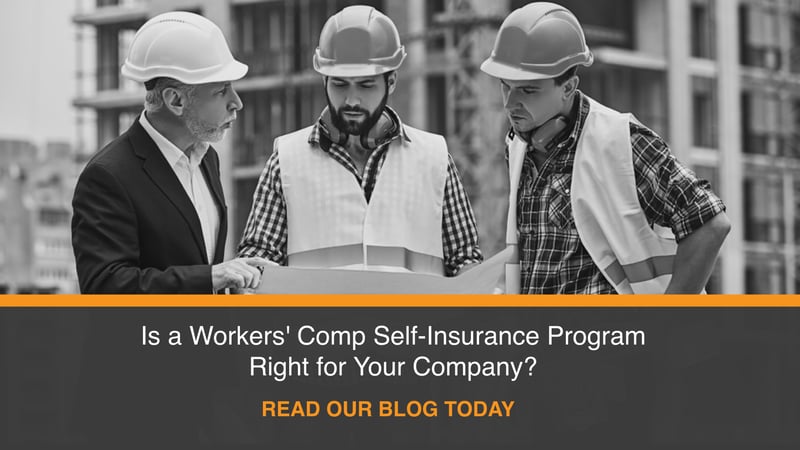 three male construction workers reviewing plans outside at jobsite