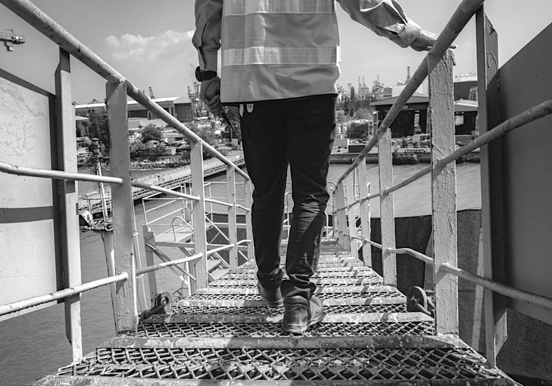 construction worker descending steel stairway to construction jobsite