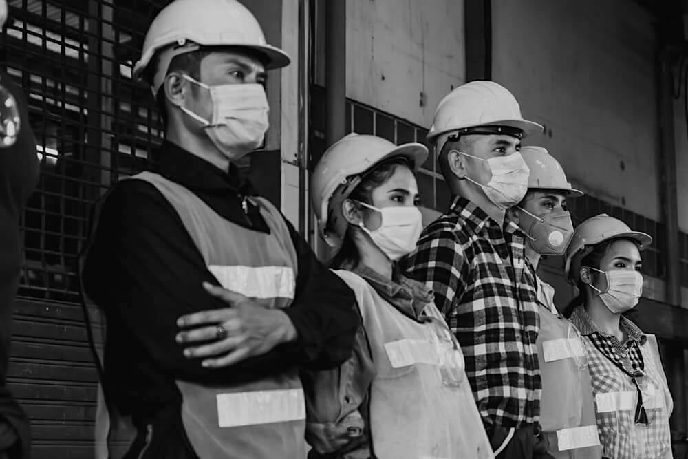 group of construction workers with safety masks during covid-19