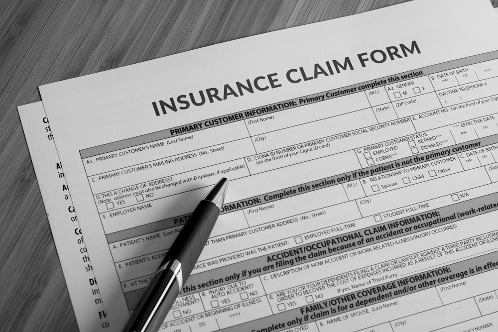 insurance claim form on desk with pen
