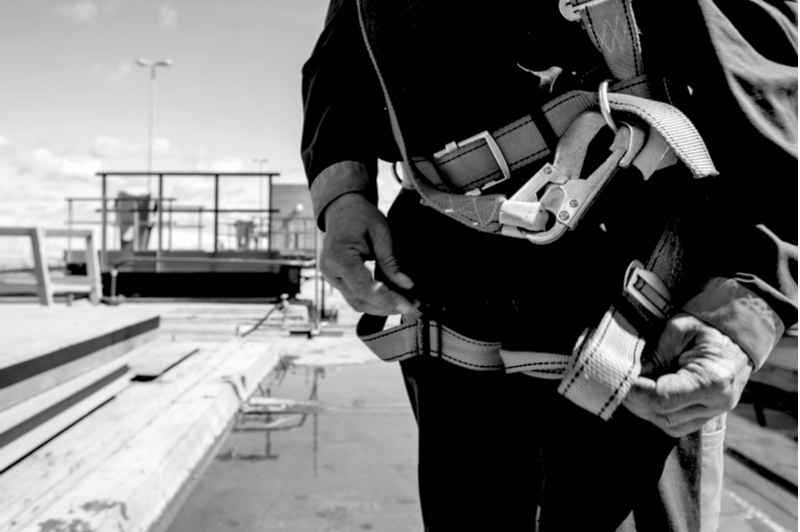 Builder Worker in safety protective equipment on bridge construction