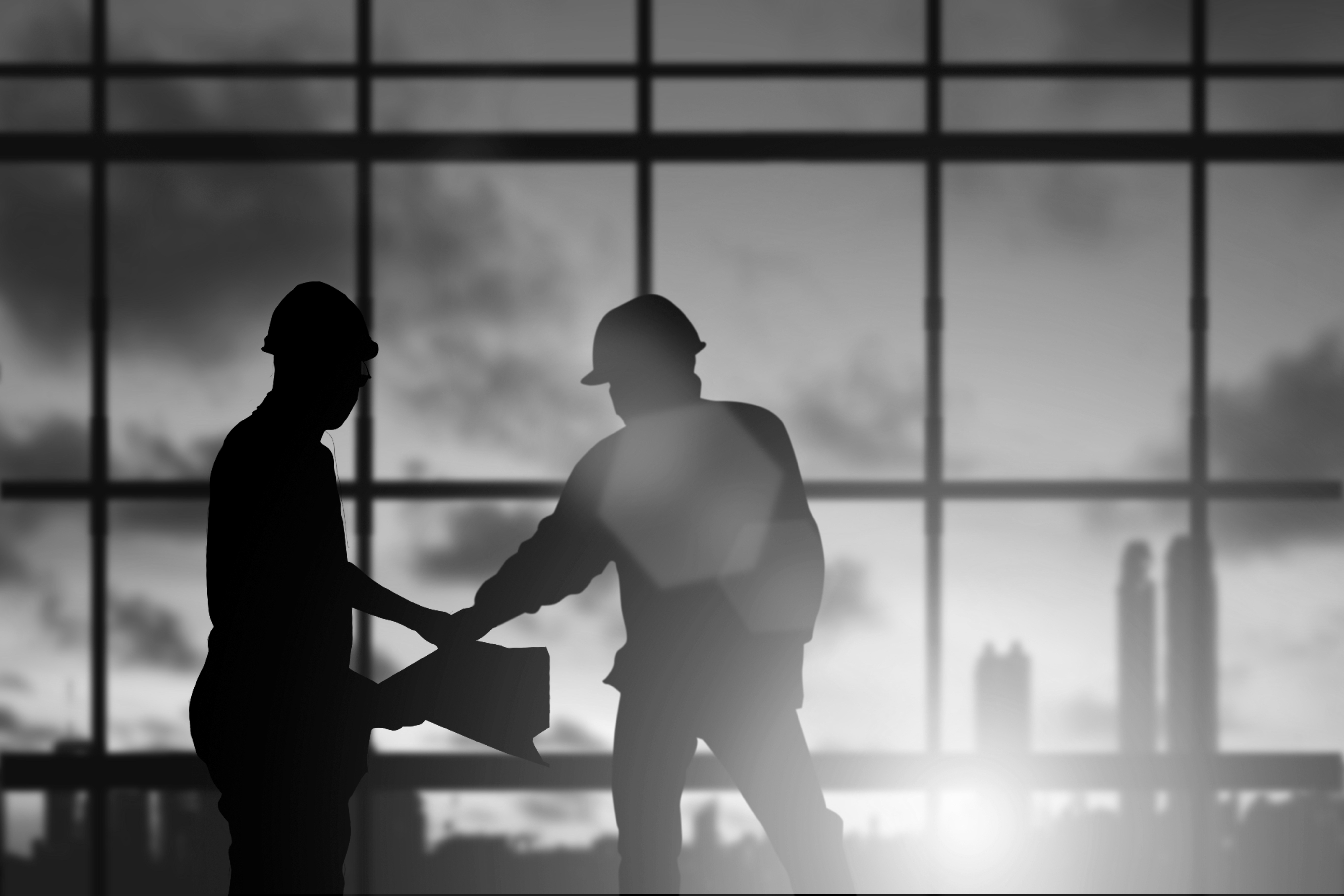 Two contractors shaking hands